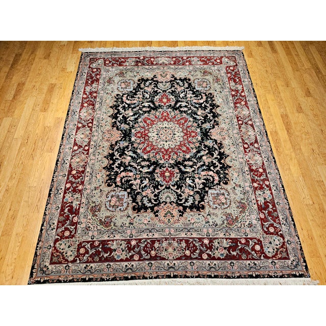 "A finely woven vintage Persian Tabriz rug in a distinctive near-square, room-size format, showcasing a richly detailed...