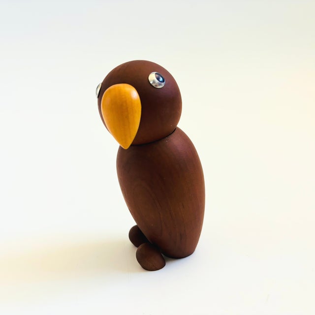 A mid century turned wood figurine in the shape of a parrot. Adorable stylized features. Made in Japan by Senshukai as...