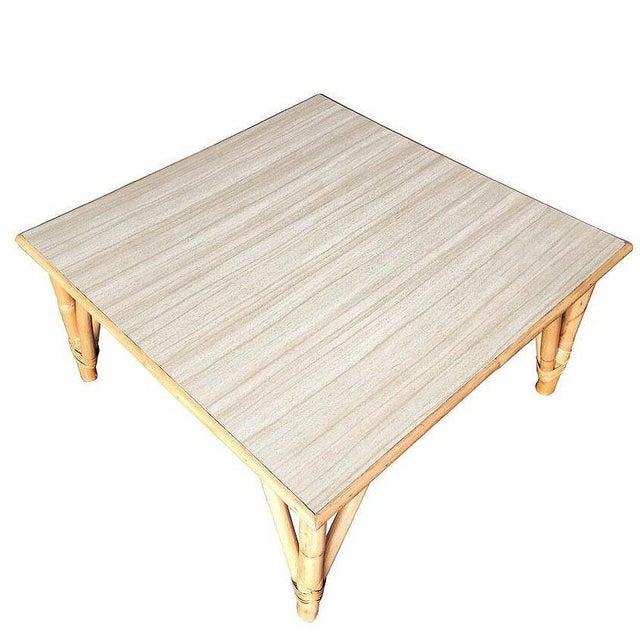 This beautifully restored large 31" long square coffee table with pole rattan legs and a wood grain formica top with a...