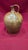 This hand-thrown 19th-century stoneware whiskey jug features a prominent ovoid body and a single pulled loop handle. The...