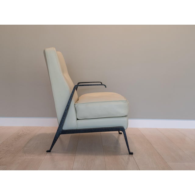 A sculptural lounge chair made in limited number in Italy by Lorenzo Tondelli, the Akan armchair pairs a tailored, button-...