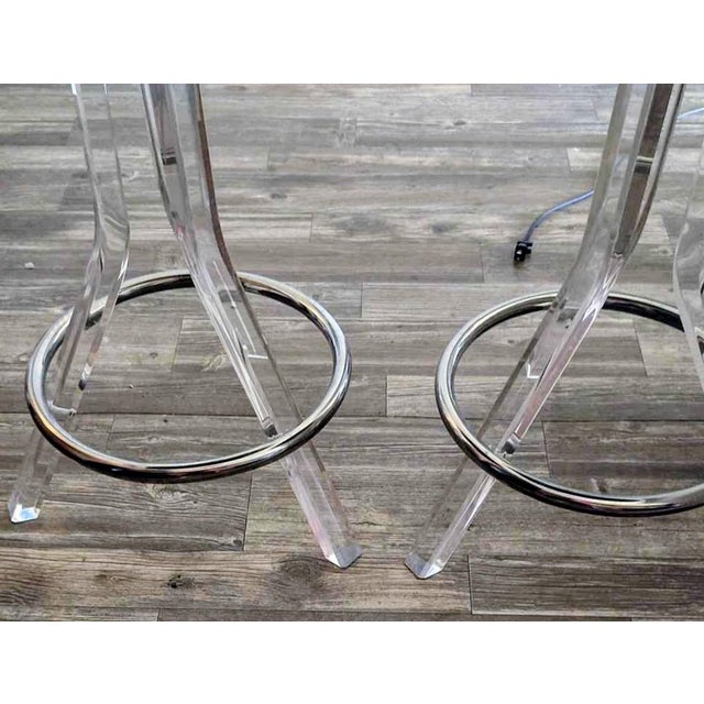 This striking set of vintage 1970s bar stools showcases the iconic Hollywood Regency and Mid-Century Modern aesthetic...