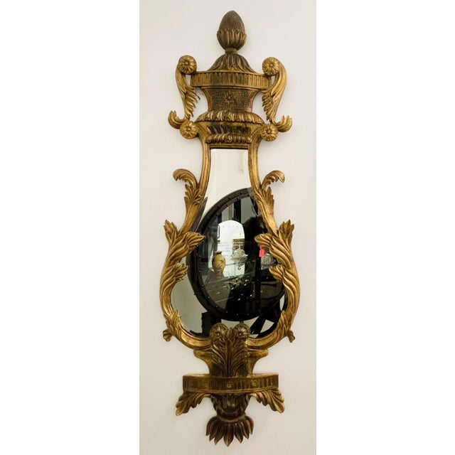 A fine pair of Italian Giltwood Wall or Console Mirrors. The pair having a harp shape with pinapple carved pedimont and...