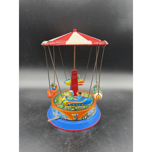Vintage tin carousel toy with ships, branded Dumbo and made in West Germany in the 1950s and 1960s. It is made of...