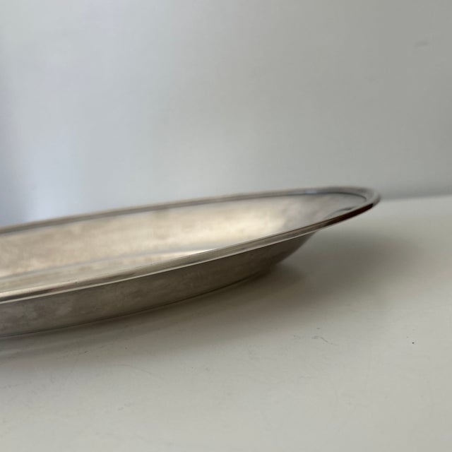 Elegant vintage silver-plated oval serving platter. Its classic shape, raised rim, and softly aged silver finish make it a...