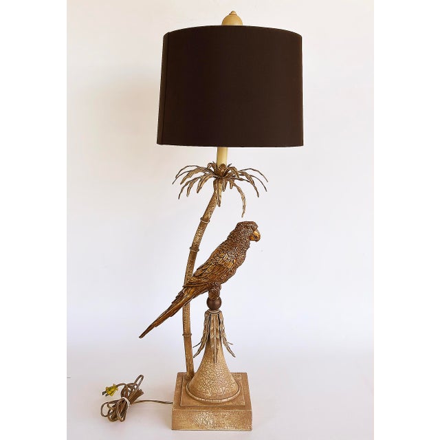 Palm Beach Chic Brass Macaw Parrot Tole Palm Tree Lamp Offered for sale is a Hollywood Regency style Brass Macaw parrot...