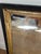 A beautifully aged antique wall mirror featuring a warm gilt-finish frame and wonderfully timeworn mirrored glass. The...