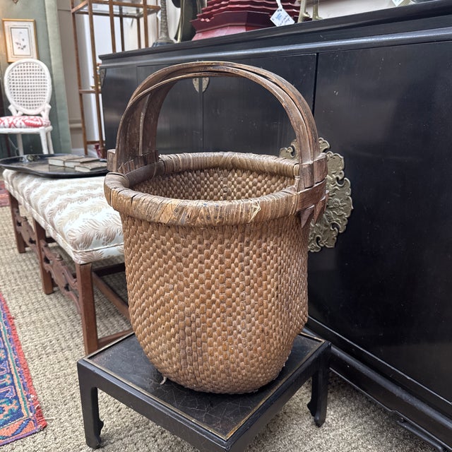 This wonderful large basket was handwoven in China and retains its rustic charm. Chinese characters are painted on one of...