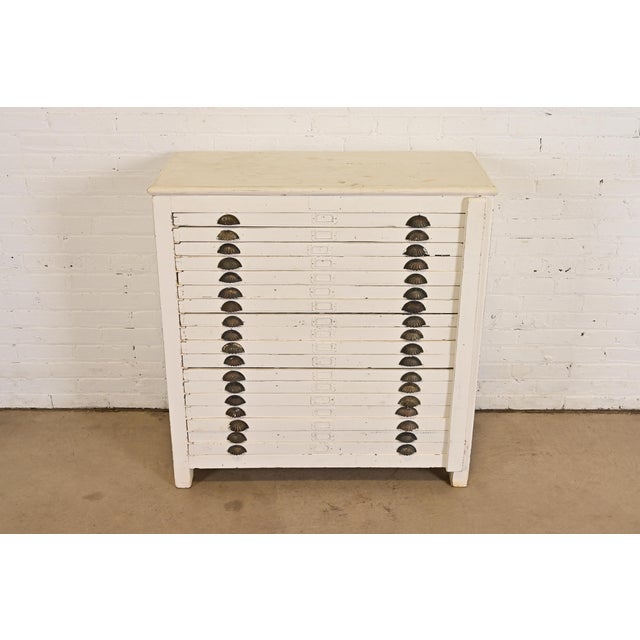 A rare antique primitive Arts & Crafts 18-drawer flat file printer's cabinet In the manner of Hamilton Manufacturing Co....