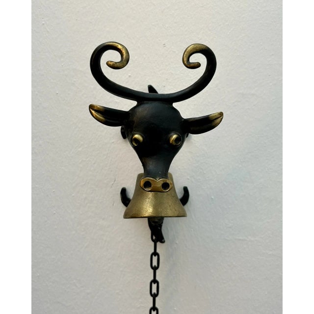 Blackened brass house bell mounted on a black lacquered aluminum frame. Attributed to the Austrian midcentury designer...