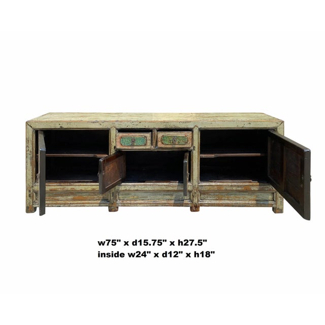 This is an oriental cabinet finished with distressed rustic light celadon green gray color. The scenery on doors is...