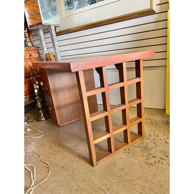 Mid Century Solid wood desk. It has 3 drawers on the left side. A unique wood lattice design on the leg.