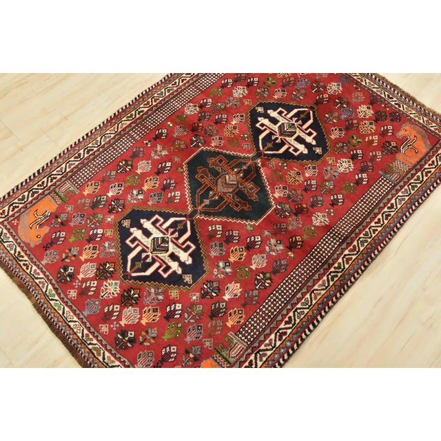 An authentic vintage tribal Qashqai rug hand-knotted with fine wool and natural dyes. This nomadic oriental rug features...
