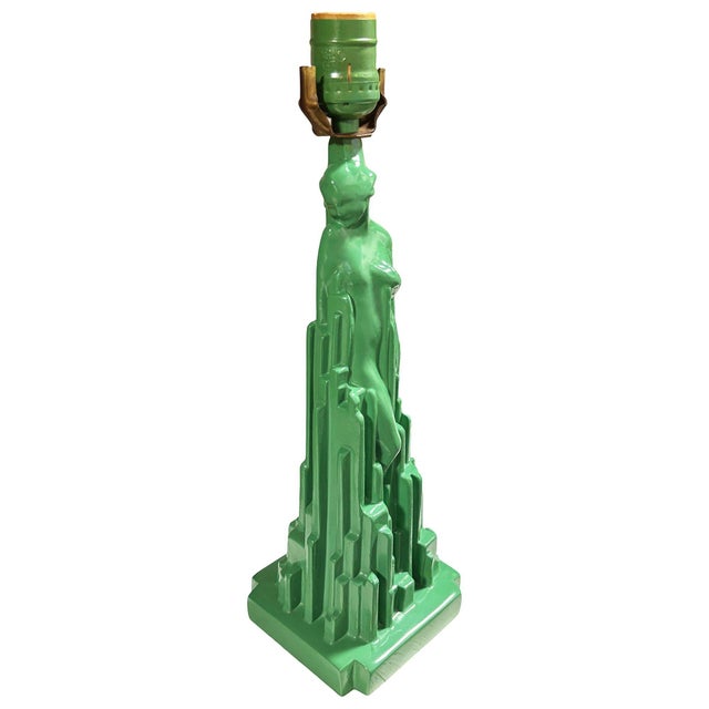 This Frankart "Spirit of Modernism" sculptural table lamp features a beautiful nude woman in the midst of the skyscraper-...