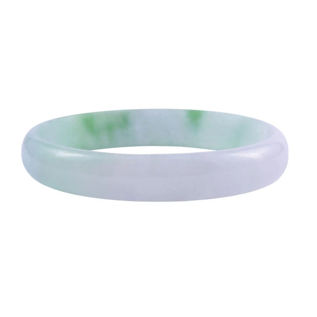 This is part of Chairish’s Fine Jewelry assortment. Vintage natural jade bangle bracelet, circa 1960-70. This bangle style...