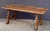 A fine Spanish low or trestle table of aged walnut from the late 18th century, featuring a rectangular plank top over a...