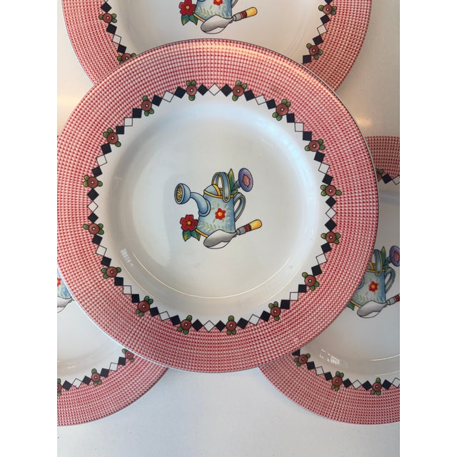 These four festive plates are from the "Garden Time" dinnerware collection designed by the iconic artist Mary Engelbreit...