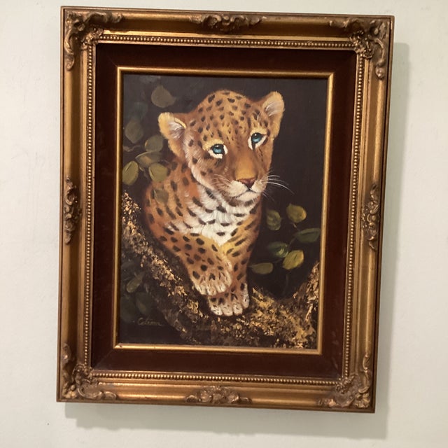 This vintage wildlife oil painting on canvas depicts a fierce leopard cub, capturing the beauty and strength of nature in...