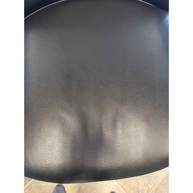 OLY exquisite chair. Beautiful sleek clean line. Iron Frame with hammered detail and wooden arms, black leather upholstery