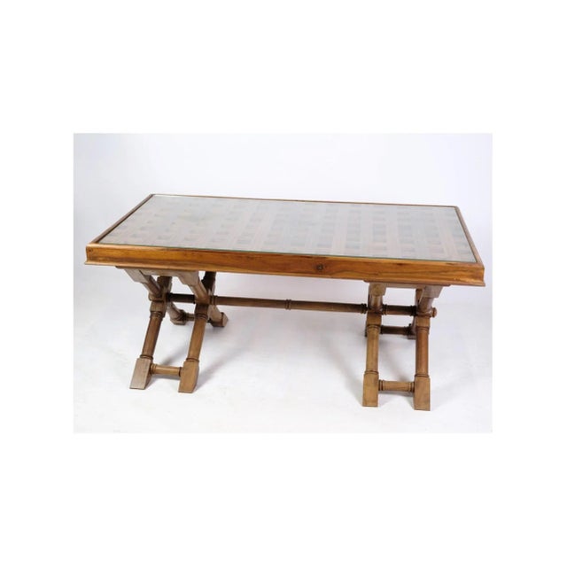 Dark wood coffee table with glass top from around the 1960s. Dimensions in cm: H: 46 W: 107 D: 62. Great condition. This...