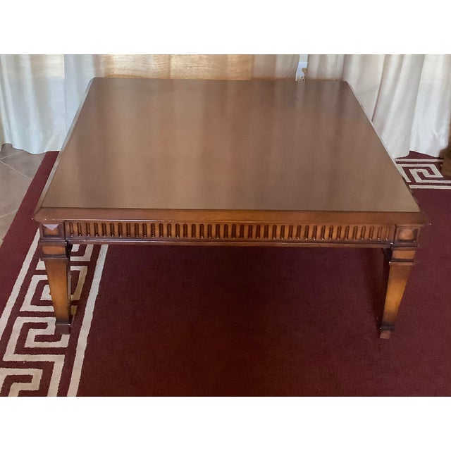 All wood walnut finish large coffee/cocktail table. Top has a unique beveled edge. Artisan quality carved sides with...