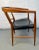 Elegant mid-century modern chair crafted from rich teak and upholstered in smooth black leather. Combines sleek...