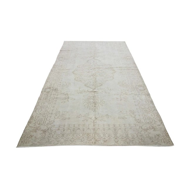 Washed out vintage handknotted rug from Oushak region of Turkey. Approximately 50-60 years old. In very good condition