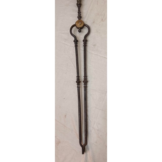 Up for sale is a large pair of rare antique 18th century wrought iron and brass English fireplace tongs. The arms are...