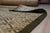 Sophisticated Nadia Black Hand Knotted Wool Rug, Country of Origin: China. This exquisite piece showcases the refined...