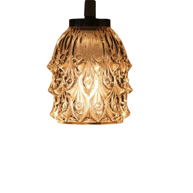 Window lamp in clear glass with knob in stainless metal. The structure of the cups is like "spikes" that stick out. It...