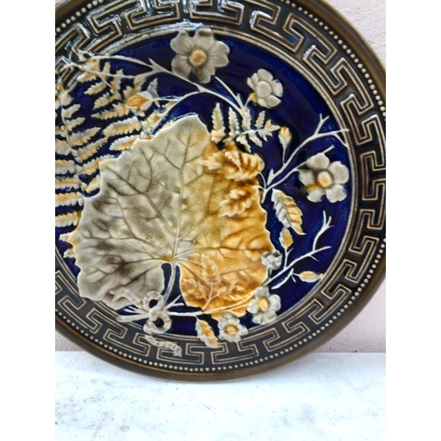 Majolica plate signed Choisy le roi, circa 1890. Decorated with leaves, ferns,flowers and Greek border. Very rare colors.