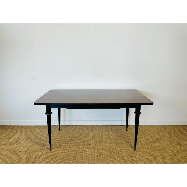 An elegant rectangular table in the Art Deco modernist style of the 1940s-50s, featuring a superb exotic wood veneer top...
