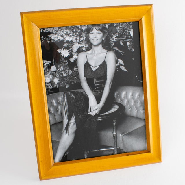 This stunning Italian Hollywood Regency picture frame boasts a lovely raised-edge shape with varnished sycamore wood. The...