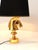 A gold-plated sculptural Hollywood Regency style table lamp from the 1970s in the shape of a horse chess piece. Made of...