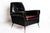 This vintage armchair is a piece of design furniture manufactured in Italy in the 1970s. Made in black leather with brass...