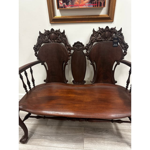 Late Victorian/Edwardian carved mahogany settee, probably circa 1890–1910, with strong Chippendale/Queen Anne Revival...
