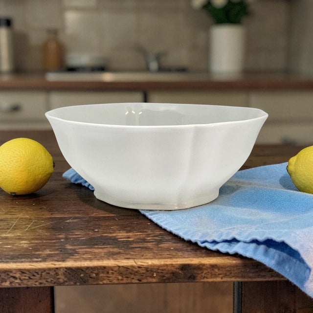 This Limoges Scalloped Serving Bowl is a beautifully preserved white porcelain serving piece with a graceful sculpted rim...