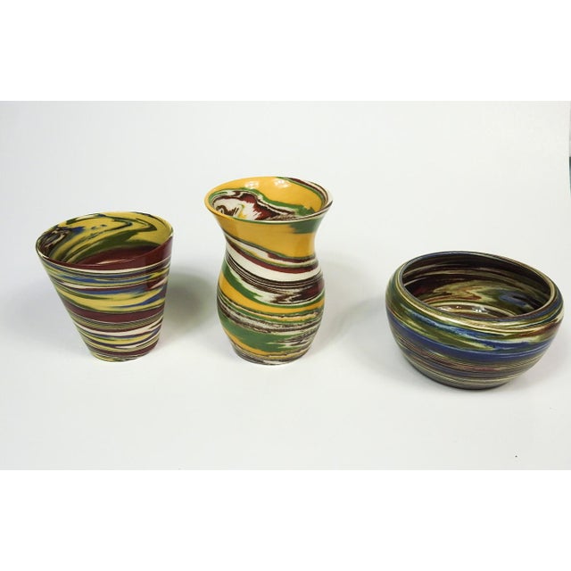Collection of three Desert Sands Pottery vases. Various shapes and swirling colors stamped on bottom. Largest tall one is...
