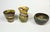 Collection of three Desert Sands Pottery vases. Various shapes and swirling colors stamped on bottom. Largest tall one is...