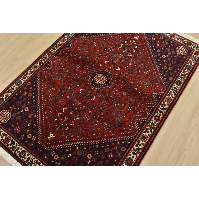 An authentic vintage tribal Abadeh rug hand-knotted with fine wool and natural dyes. This intricately woven rug features a...