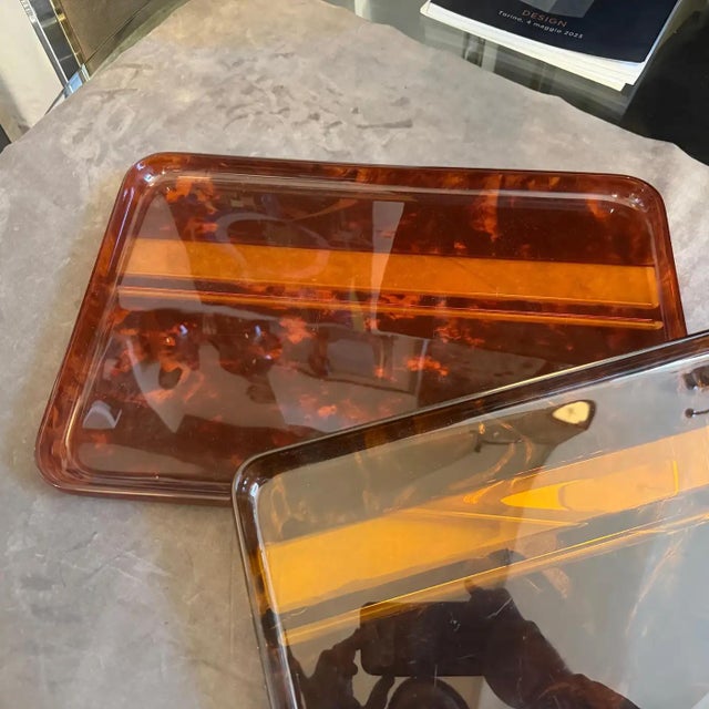 This set of two 1970s mid-century modern trays by Guzzini showcases a sophisticated faux tortoiseshell aesthetic crafted...