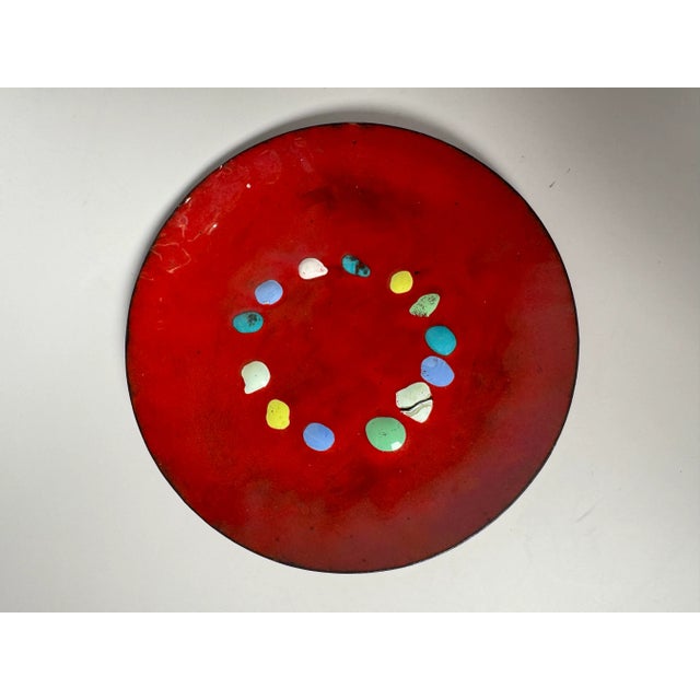 Glossy red enamel holds the background to organic concentric free-formed painted dots in blue, mint, turquoise, yellow,...