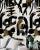 A truly abstract masterpiece, on a white background, with an energetic palette of bold black brush-like strokes. Golden,...