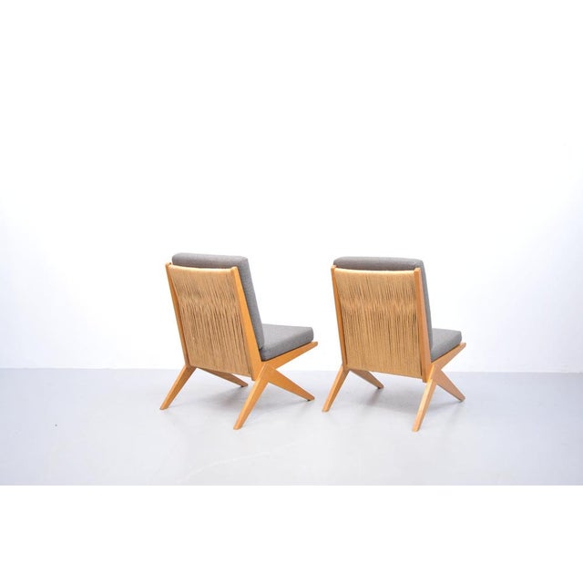 A set of two rare Scissor Chairs, attributed to Pierre Jeanneret. Made of solid ash wood, with original seat cushions...