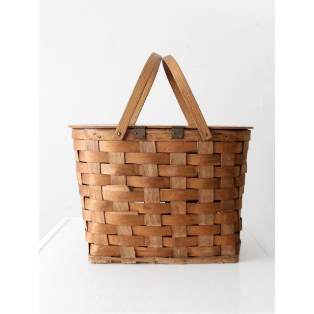 A timeless piece of Americana, this vintage picnic basket boasts a classic splint weave and hinged bentwood handles. Its...