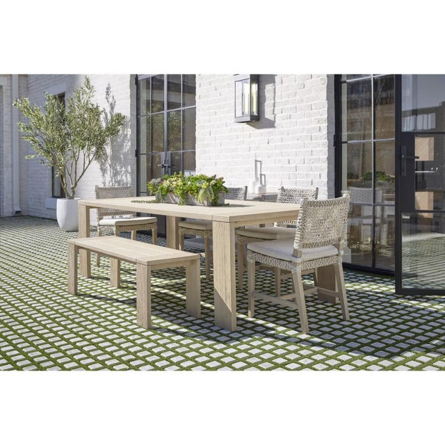 The Sur Wooden Backless Outdoor Dining Bench pairs solid teak construction with a washed finish that stands up to weather...