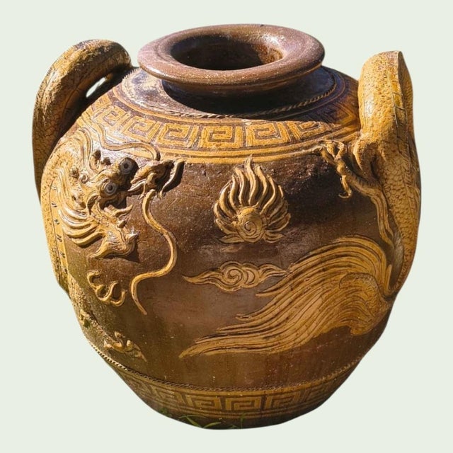 massive antique Chinese earthenware Martaban Dragon Jar of brown and mustard glaze depicting a pair of celestial dragons...