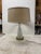 Vintage mid century Murano glass table lamp on circular brass base with vintage shade. Moulded glass base has unique...