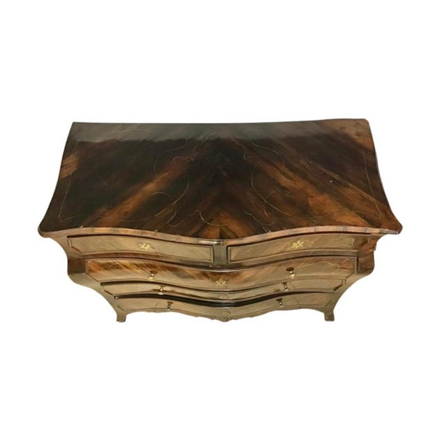 A large and imposing Italian Rococo Rosewood Inlaid Commode. The serpentine top sits above a subtle bombè case, fitted...