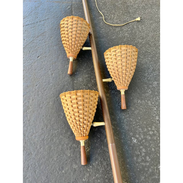 Mid Century modern tension pole floor lamp. Pole does have springs inside, spring loaded. The 3 light shade are woven...